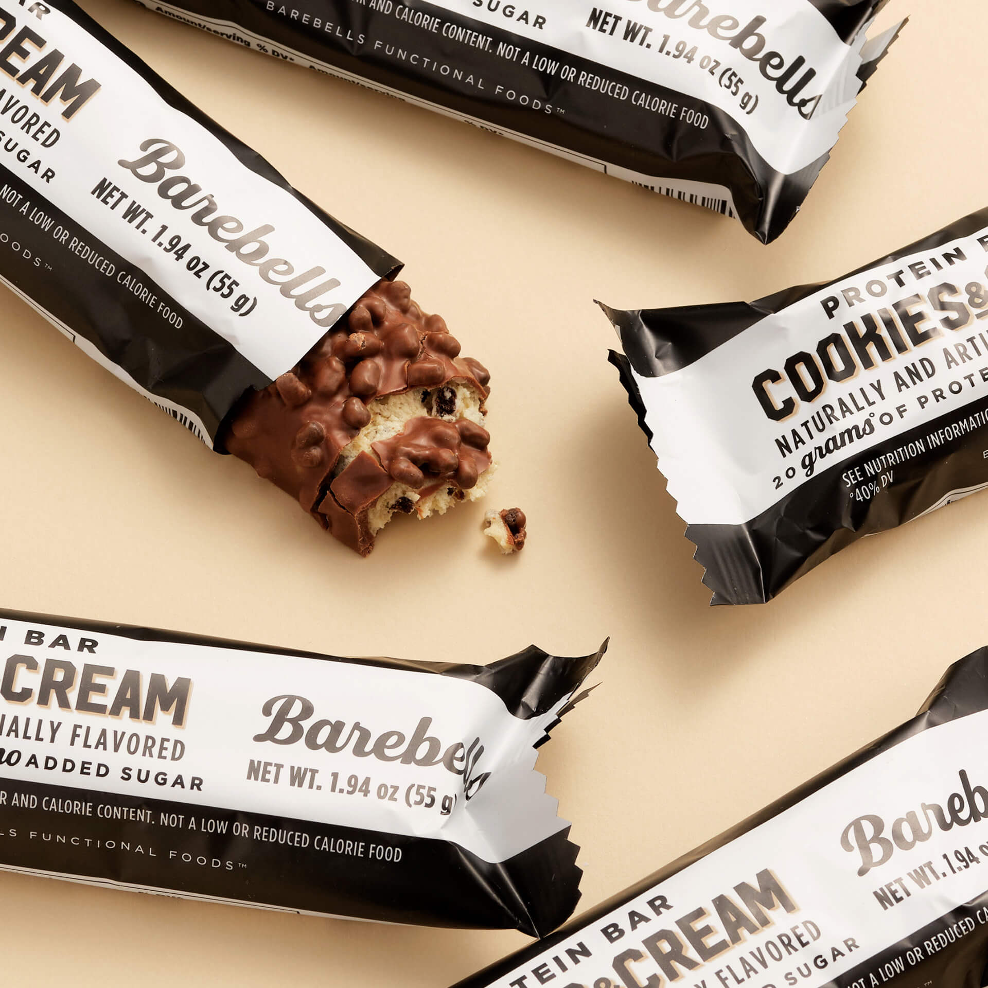 Barebells Protein Bars in Cookies & Cream flavor on a beige background